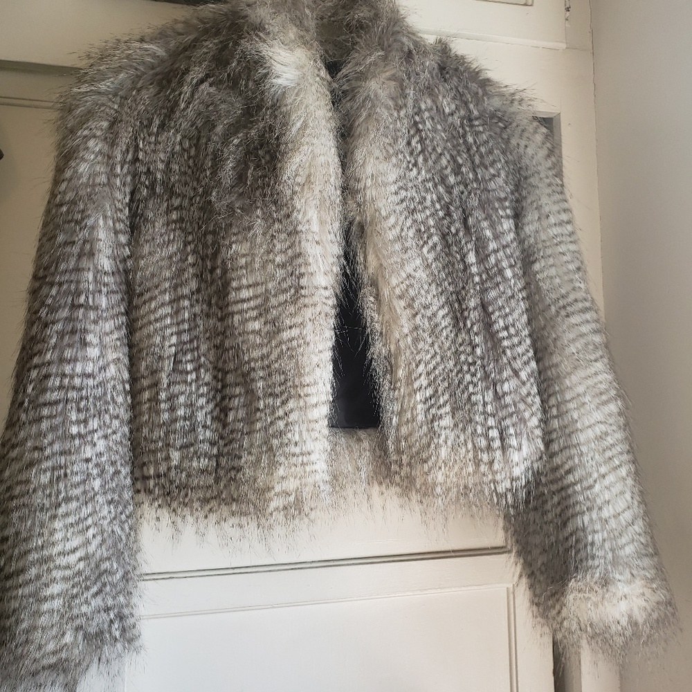 Short faux fur coat.